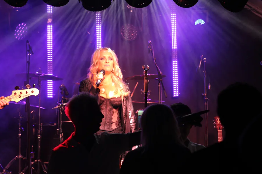 Singer under purple stage lighting