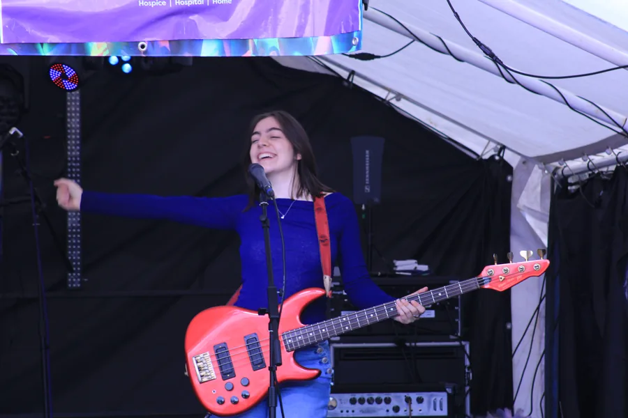 Bassist performing on the outdoor stage