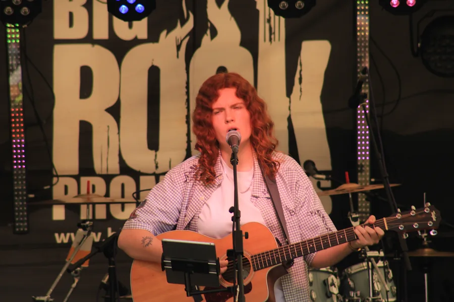 Acoustic performer under warm stage light